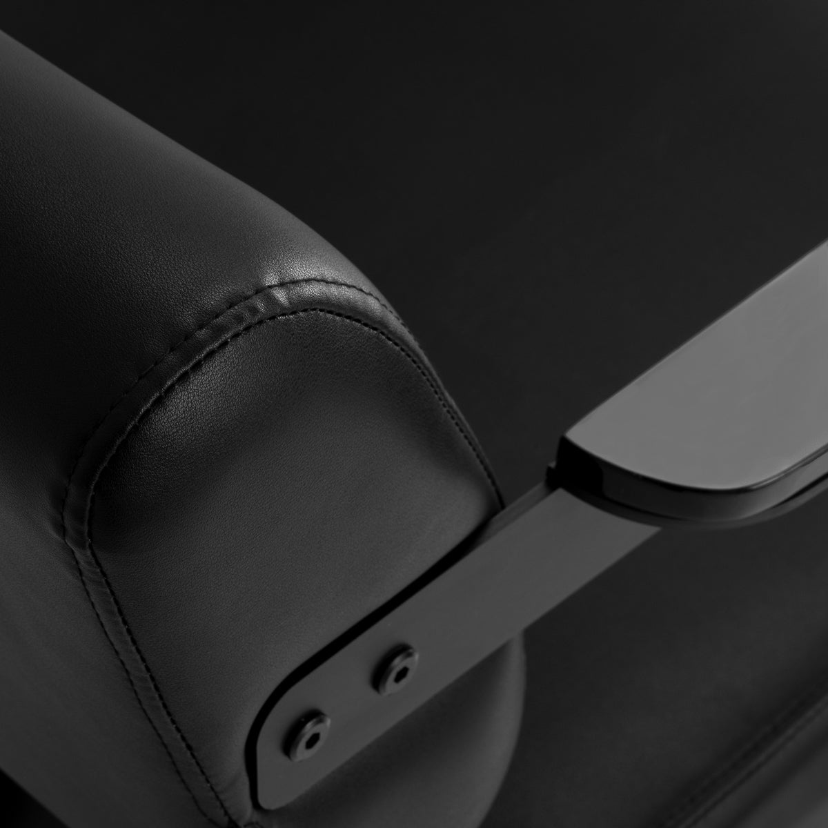 Black Jet noir hairdressing chair by HAIR SYSTEM with cushioned seat and backrest, adjustable height, and sleek modern design.
