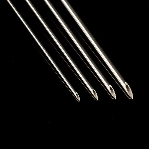 Sterile disposable piercing needles from BVShop, showing multiple thin, sharp needles used for body piercings.