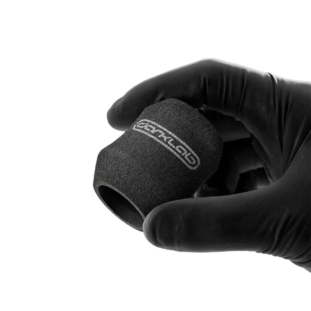 FK Irons Ergo Disposable Foam Grip Covers shown on tattoo machine for comfortable, hygienic grip during tattooing.