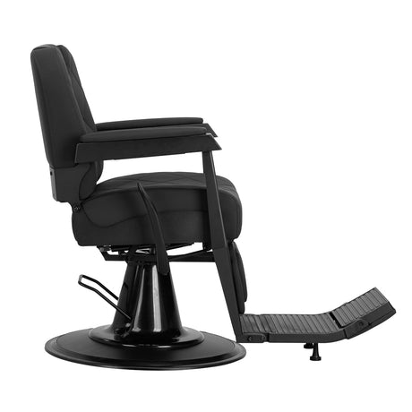 Gabbiano Bruno barber chair with black frame, padded seat and backrest, adjustable armrests, in a professional barbershop setting.
