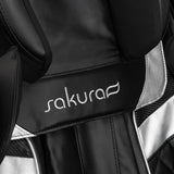 Black Sakura Prime 108 massage chair with padded armrests and footrest, showcasing a sleek, modern design in a massage furniture style.