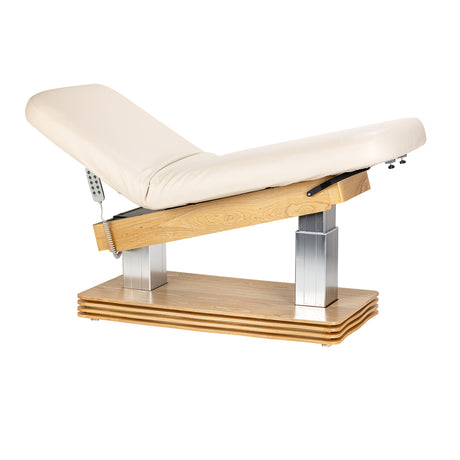 Cream-colored SPA lounger Sillon Comfort with light brown base, ergonomic beauty salon furniture for relaxing treatments.