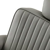 Gabbiano Visionerio barber chair with grey upholstery and chrome frame, designed for barbershop furniture.