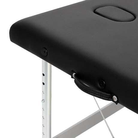 BALANCE aluminium folding massage table with three segments in black, featuring a sturdy frame and padded surface for comfort.