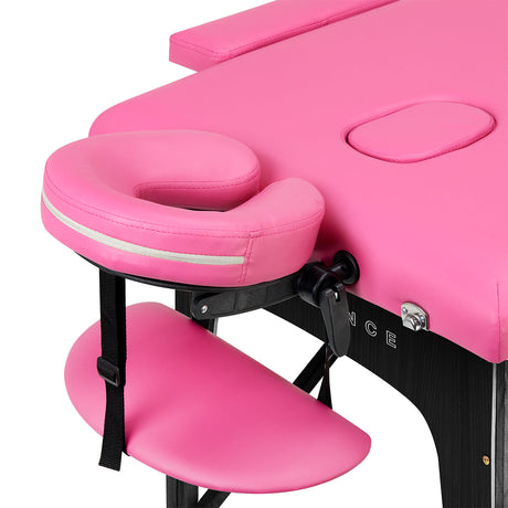BALANCE wooden folding massage table with pink and black upholstery, featuring two adjustable segments for professional massage therapy.