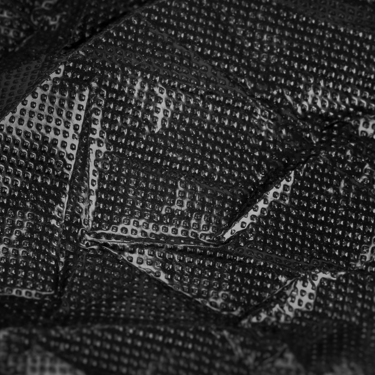 Black disposable plastic sheet with elastic band by EL CARTEL, shown with secure elastic edges for protective coverage.