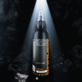 Kwadron INX UniShader #3 tattoo pigment bottle, 120ml or 240ml, with vibrant ink visible in a professional tattooing setup.