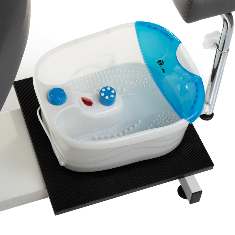 Gray pedicure chair with built-in foot massager from Beauty System, featuring armrests, plush upholstery, and a sleek design.