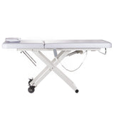 White electrical rehabilitation table BY-1041 by Beauty System with padded surface and adjustable features for therapy sessions.