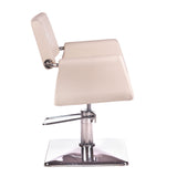 Cream-colored Beauty System Vito hairdressing chair with cushioned seat and backrest, adjustable height and sleek design.