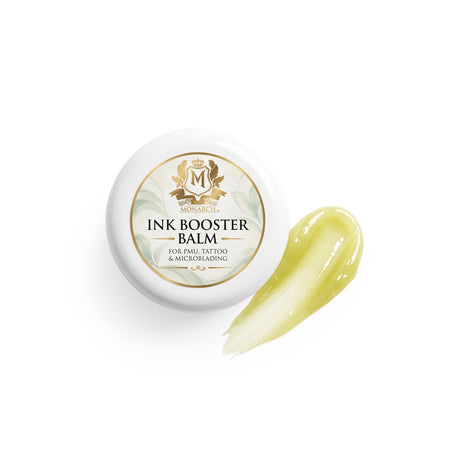 Skin Monarch Ink Booster Balm 30ml, καπάκι δίπλα σε δείγμα γυαλιστερού κίτρινου βάλσαμου