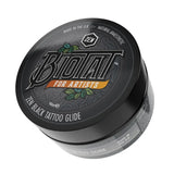 Biotat Zen Black Tattoo Glide 100g jar showing black tattoo lubricant with label and open lid, used for tattooing.