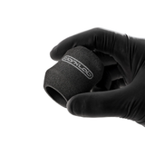 FK Irons Ergo Disposable Foam Grip Covers shown on tattoo machine for comfortable, hygienic grip during tattooing.